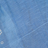 The ALEMAIS Yasmeen Embellished Midi Dress showcases a blue fabric with subtle texture, plain blue sections, faint horizontal lines, and simple white geometric patterns along the left edge—perfect for chic resort wear.