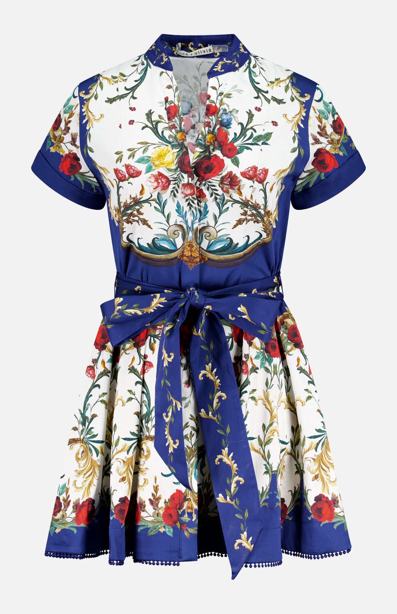 The Lucy Short Sleeve Mini Shirt Dress With Tie Belt by ALICE + OLIVIA features a deep V-neck, red, yellow, and green floral print on white, blue borders, short sleeves, and a wide blue sash at the waist.