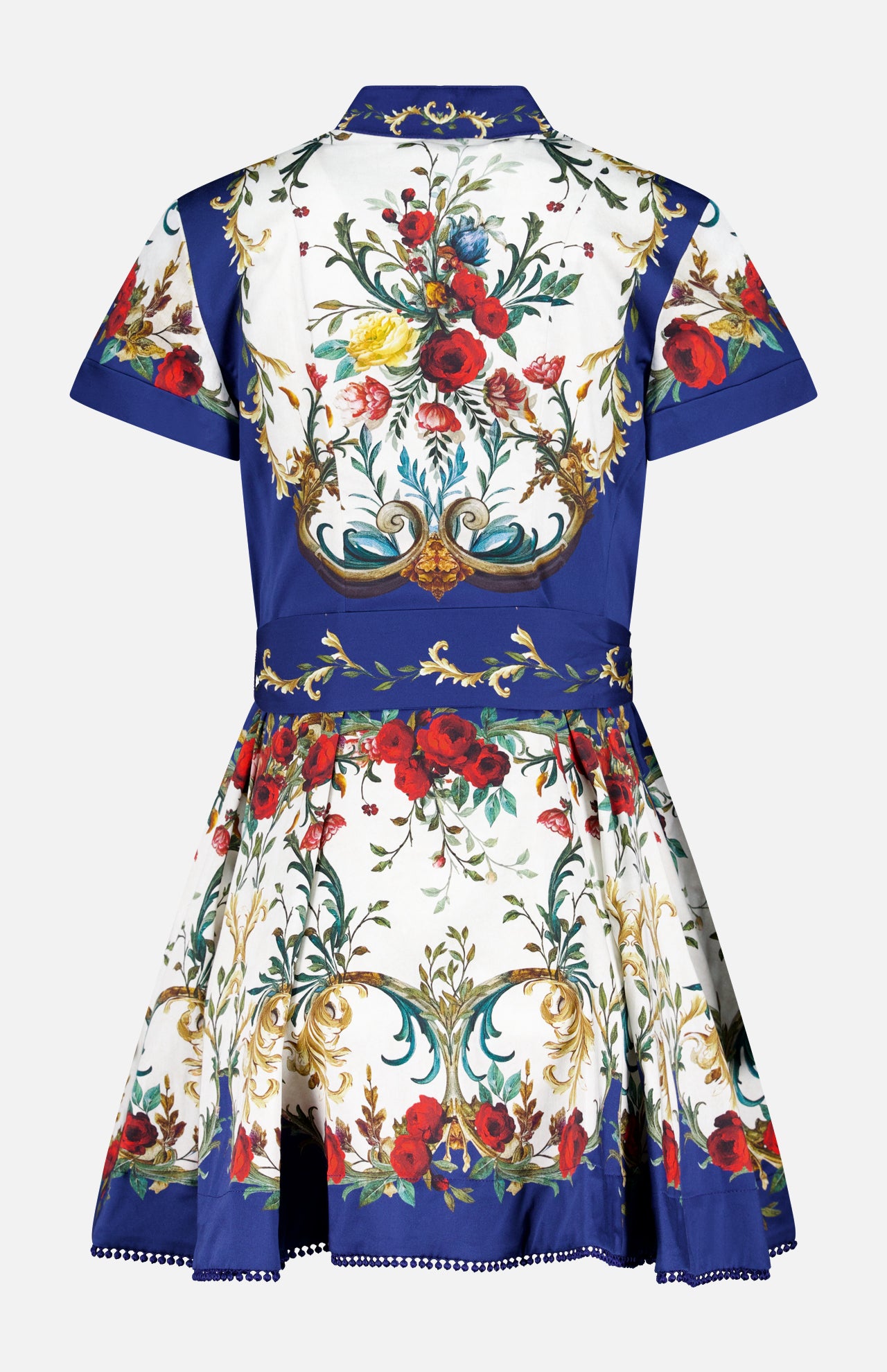 The ALICE + OLIVIA Lucy Short Sleeve Mini Shirt Dress With Tie Belt features a flared cotton poplin skirt and collared design, adorned with ornate red, green, and gold floral scrolls on a white and royal blue background.