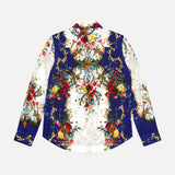 The ALICE + OLIVIA Willa Concealed Placket Top is a long-sleeve crepe de chine shirt with a vibrant floral and vine print in red, green, and gold on white and royal blue, shown flat with the back facing up.