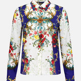 The Willa Concealed Placket Top by ALICE + OLIVIA is a long-sleeved silk blouse featuring vibrant red, blue, green, and gold floral and baroque patterns on white, with symmetrical florals and scrollwork for a striking vintage look.