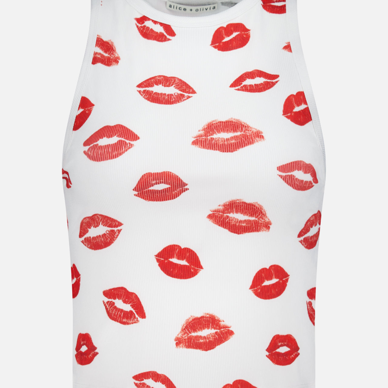 The ALICE + OLIVIA Allen Printed Lips Tank Top is a white sleeveless crop top featuring a playful red lips print, adding a flirty touch to any casual outfit.