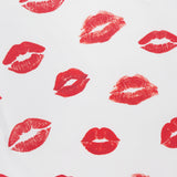 The Allen Printed Lips Tank Top by ALICE + OLIVIA features red lips scattered on a white background, creating a bold graphic look.