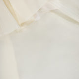 Close-up of layered, sheer organza fabric in off-white or cream with soft folds and a delicate, translucent texture—perfect for the ALICE + OLIVIA Alta Off The Shoulder Ruffle Blouse.