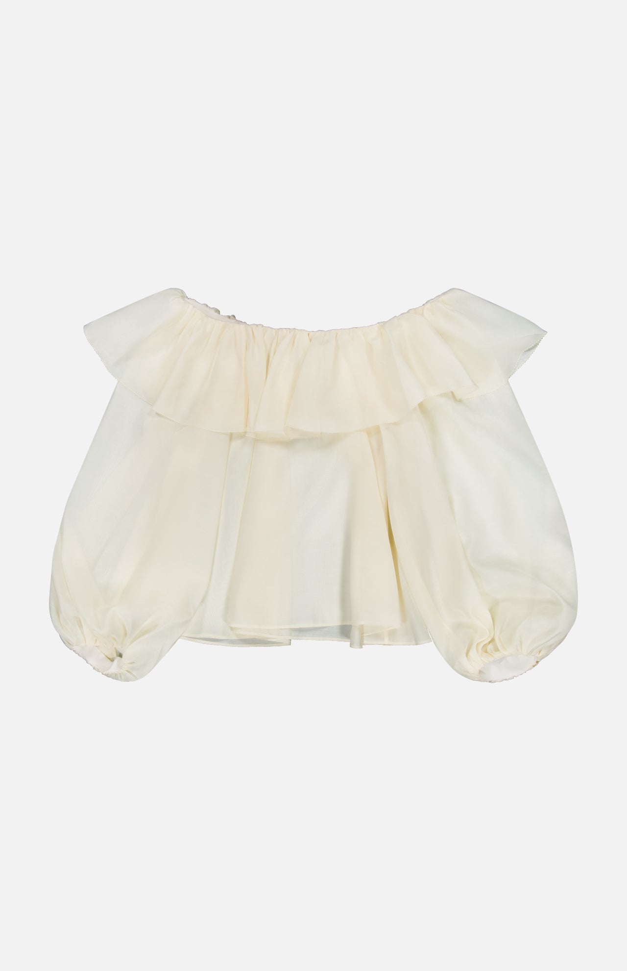The ALICE + OLIVIA Alta Off The Shoulder Ruffle Blouse features an off-white, sheer organza design with short puffy sleeves and ruffle detailing along the neckline. It is displayed against a plain white background.