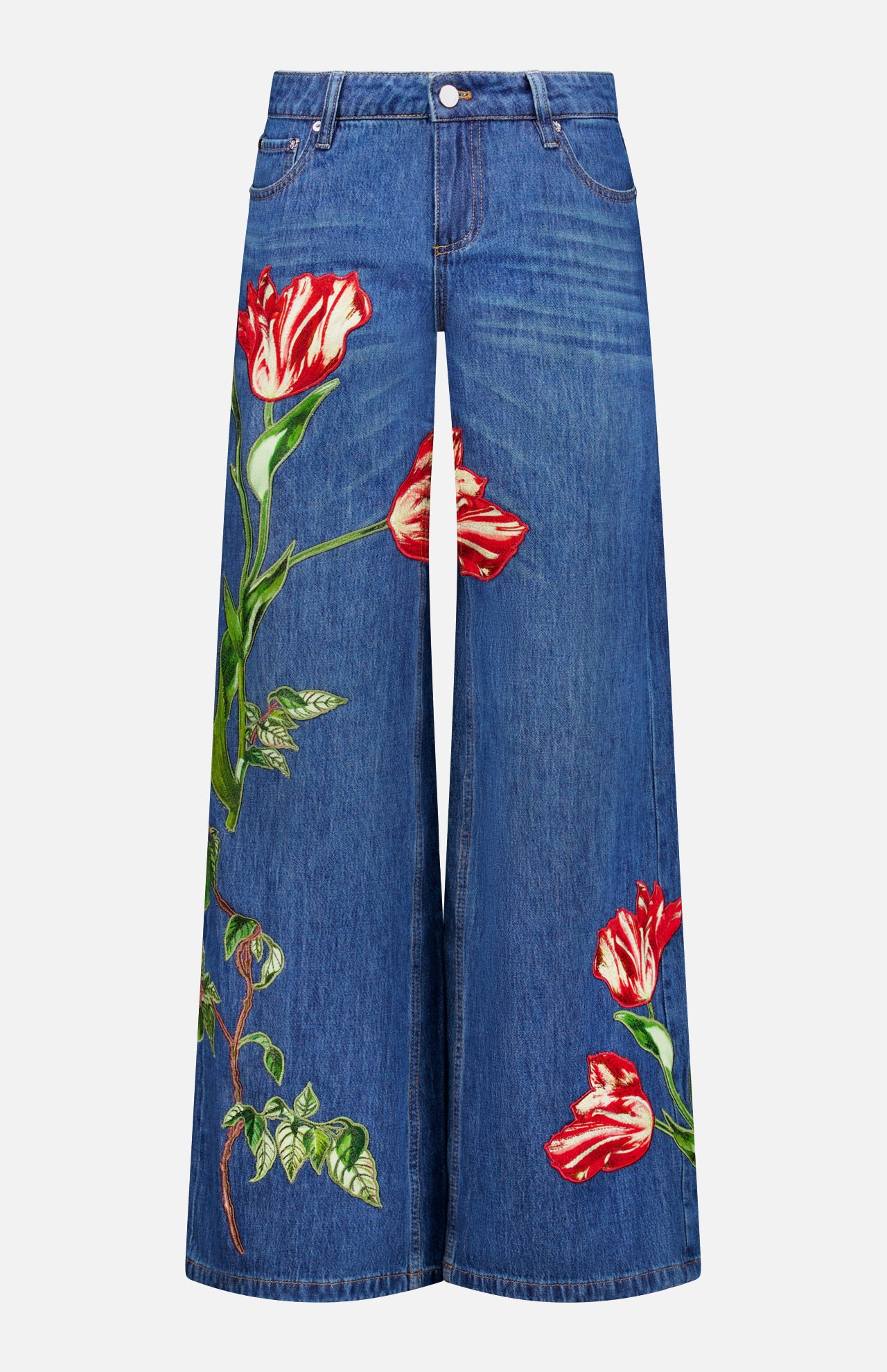 Low-rise baggy jeans in the Freyja wash by ALICE + OLIVIA, featuring a wide-leg dark blue silhouette with bold red and white tulip-shaped embroidered floral appliques on both legs. These jeans are designed with front pockets, a waistband with belt loops, and a button closure.