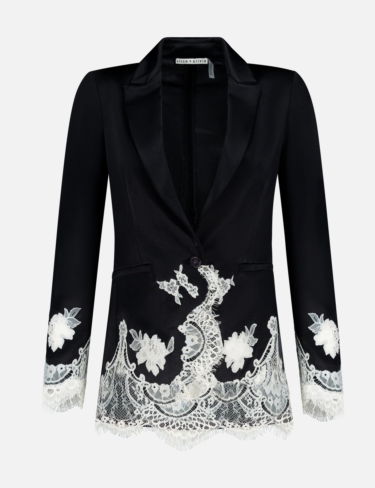The Breann Cutaway Lace Long Fitted Blazer by ALICE + OLIVIA features a sculpted silhouette with white floral lace trim on the cuffs and hem, single button closure, and peak lapels, shown on a plain white background.