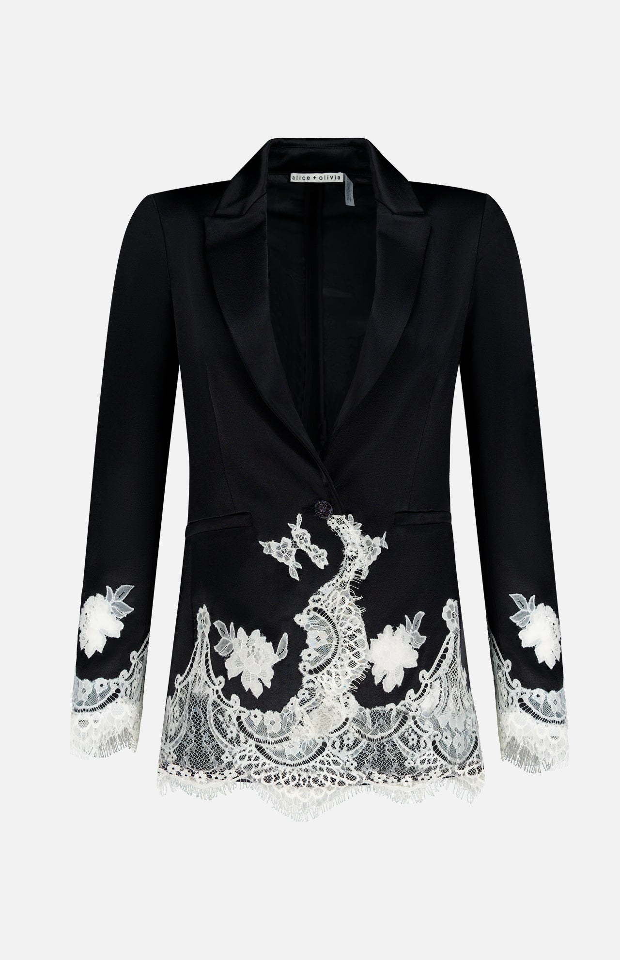 The Breann Cutaway Lace Long Fitted Blazer by ALICE + OLIVIA features a sculpted silhouette with white floral lace trim on the cuffs and hem, single button closure, and peak lapels, shown on a plain white background.