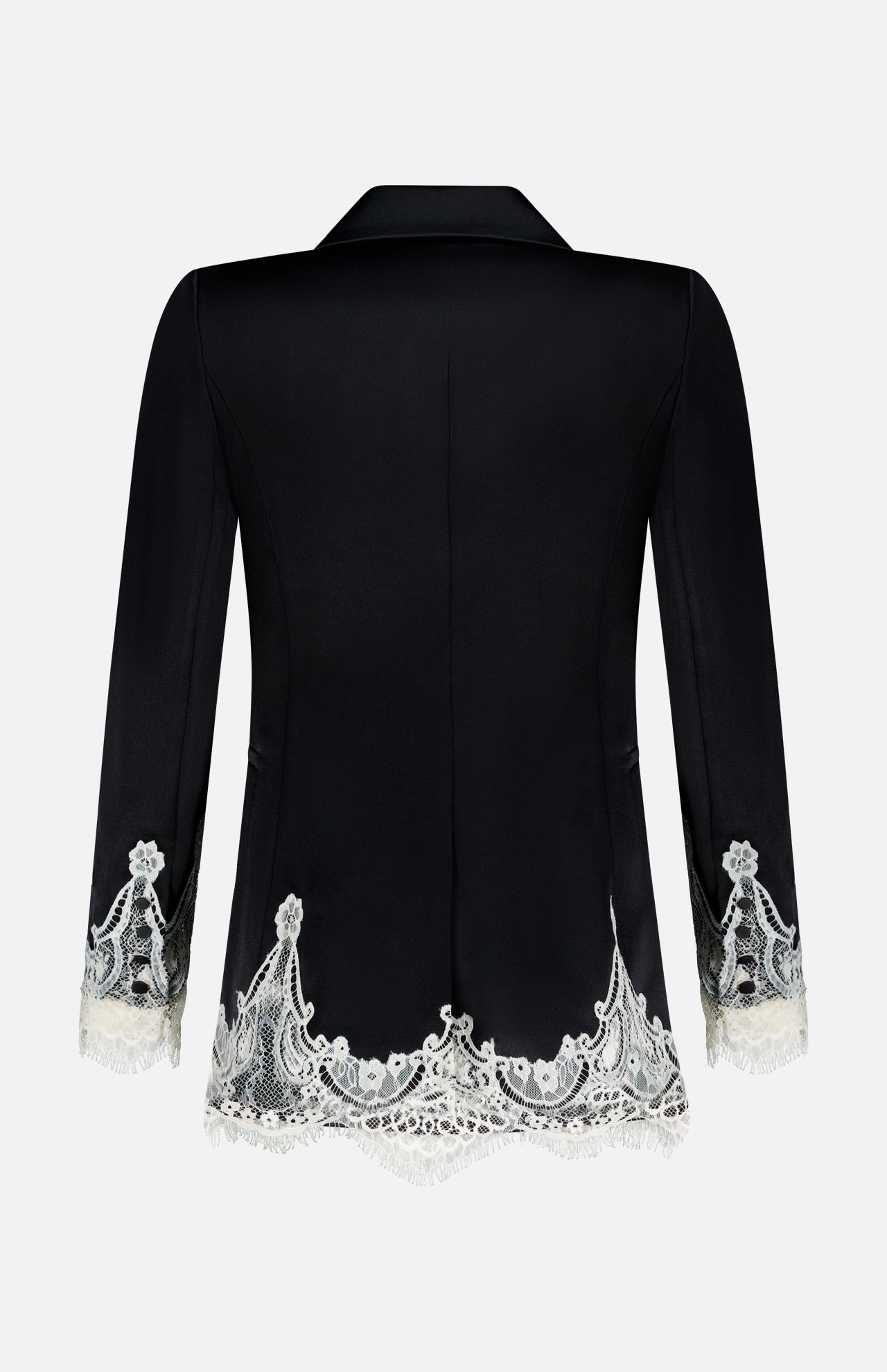 The Breann Cutaway Lace Long Fitted Blazer by ALICE + OLIVIA features black fabric with white cutwork lace trim along the hem and cuffs, creating a sculpted silhouette when viewed from the back.