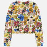 The Carson Floral Printed Cardigan by ALICE + OLIVIA is a long-sleeve, cropped cardigan adorned with a vibrant floral print in blue, red, yellow, and green on a white background, laid flat with the back facing up for a vintage-inspired look.