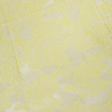 The Charlotte Scoop Neck Mini Dress by ALICE + OLIVIA is a butter yellow mini dress with a metallic floral jacquard pattern on light cream fabric, perfect for an elegant cocktail party look.
