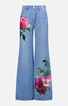 The ALICE + OLIVIA Chic Full Length Jean in Denver is a light blue high-rise, wide-leg style with large pink and red floral prints on the thigh and leg—perfect for adding a playful touch to any women’s denim collection.