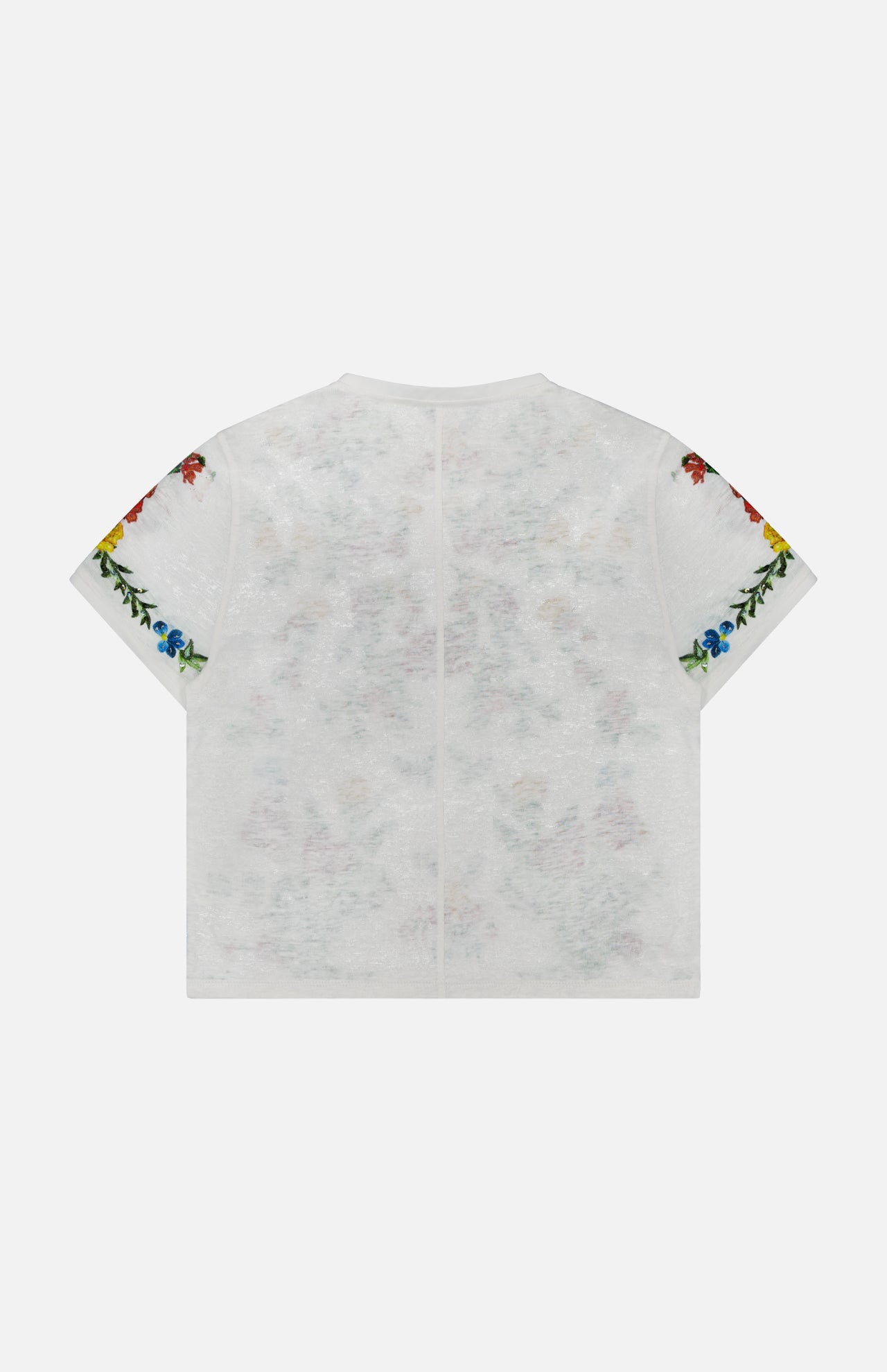 The Cindy Embroidered Cropped T-shirt by ALICE + OLIVIA is shown laid flat with the back facing up, highlighting its colorful floral embroidery along the edges of both sleeves. This chic white tee features a playful, delicate floral design that adds a vibrant touch to any outfit.