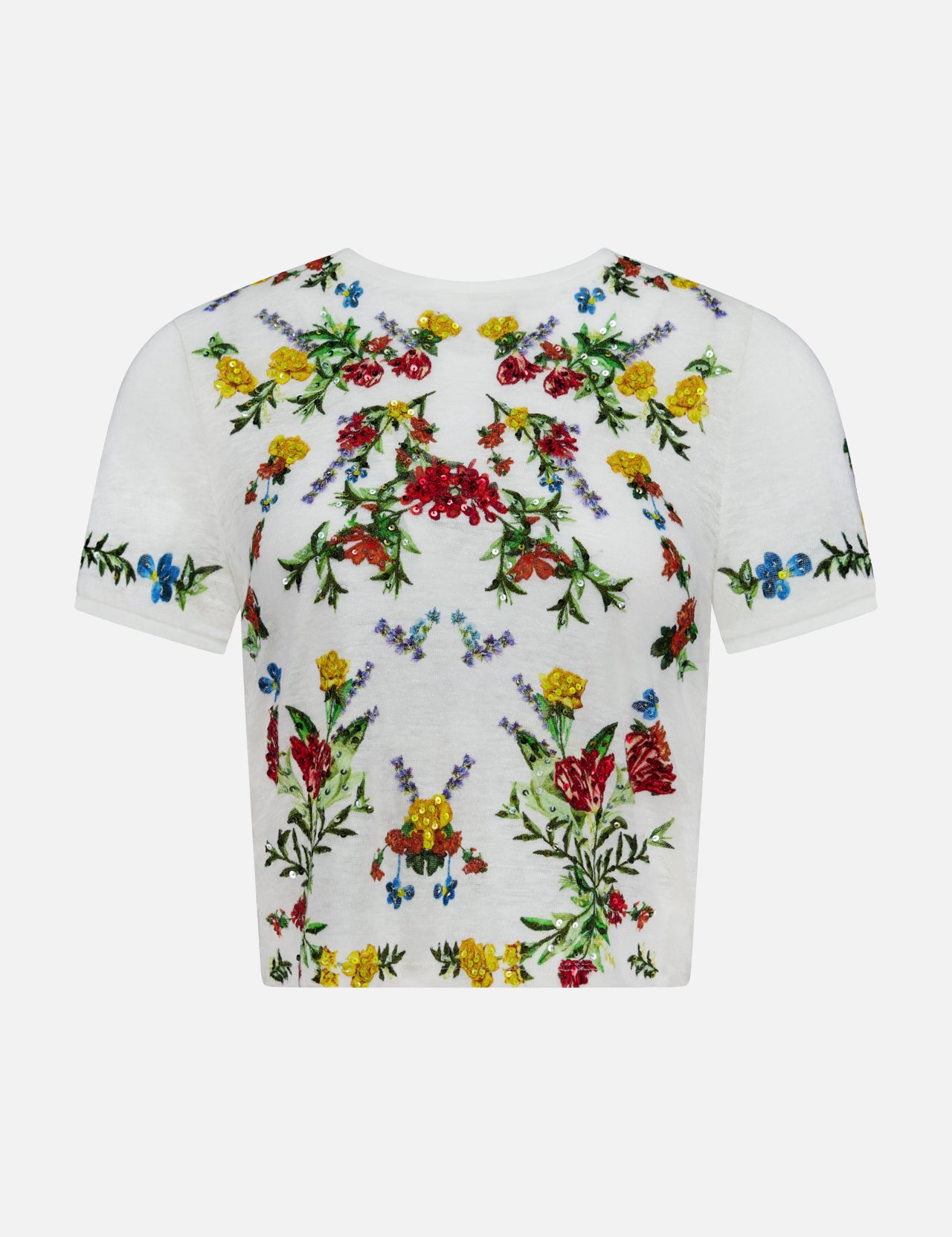 The Cindy Embroidered Cropped T-shirt by ALICE + OLIVIA is a white tee adorned with vibrant floral embroidery in red, yellow, blue, and green across the front, sleeves, and neckline. Delicate floral design details and sparkling sequin embellishments add a touch of shimmer. The t-shirt is displayed against a plain white background.