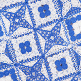 Blue and white crochet blanket with alternating star and square patterns, showcasing intricate, lacy designs and a repeating geometric motif—reminiscent of the delicate craftsmanship found in the ALICE + OLIVIA Clyde A-Line Shift Dress.