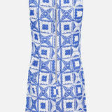 The Clyde A-Line Shift Dress by ALICE + OLIVIA is a sleeveless shift dress showcasing a blue and white crocheted square pattern. Seen from the back, it features a prominent center zipper.