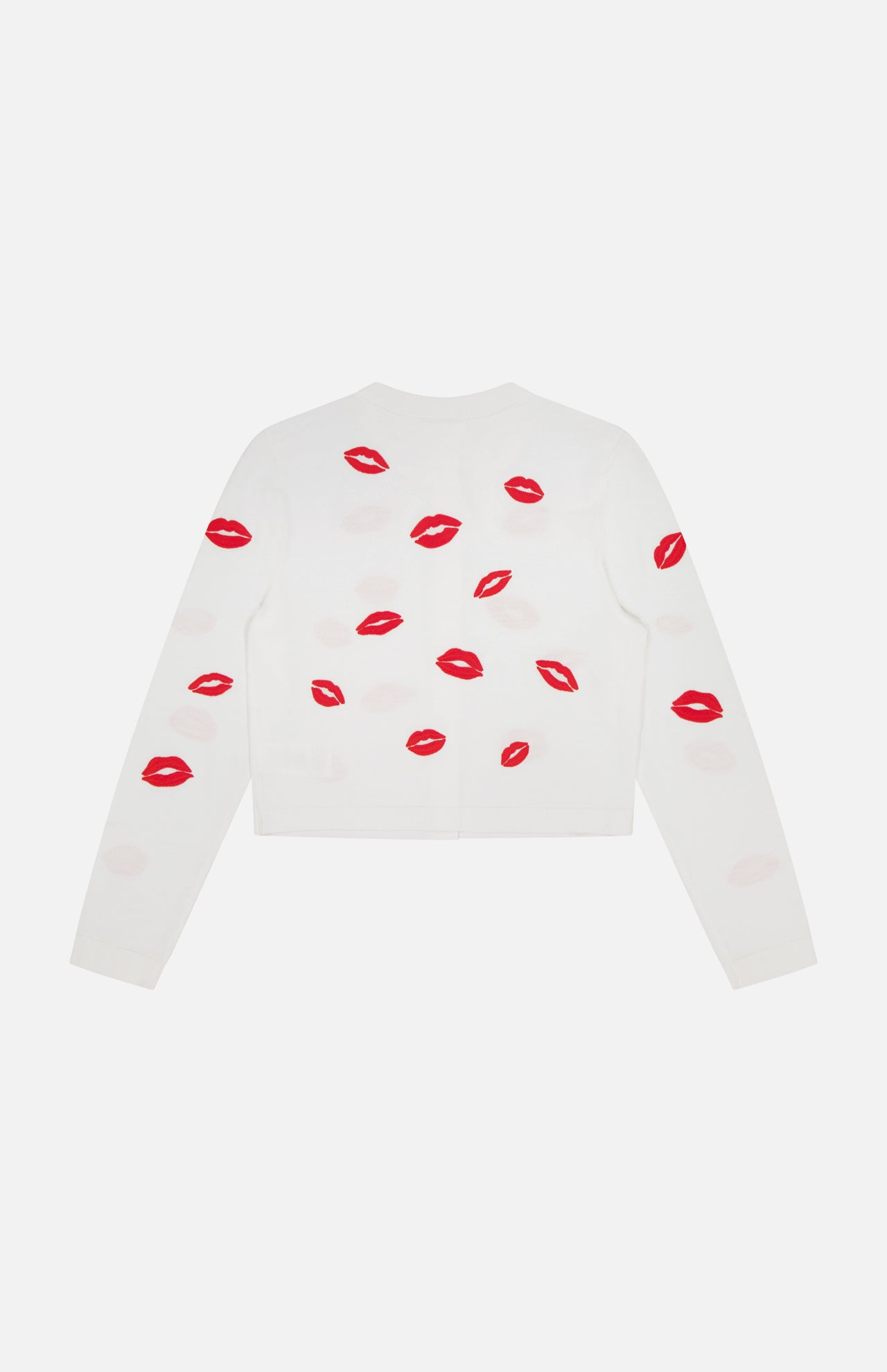 The ALICE + OLIVIA Daroda Lip Cardigan Sweater is a white cropped knit, detailed with red embroidered lips scattered across the back and sleeves.