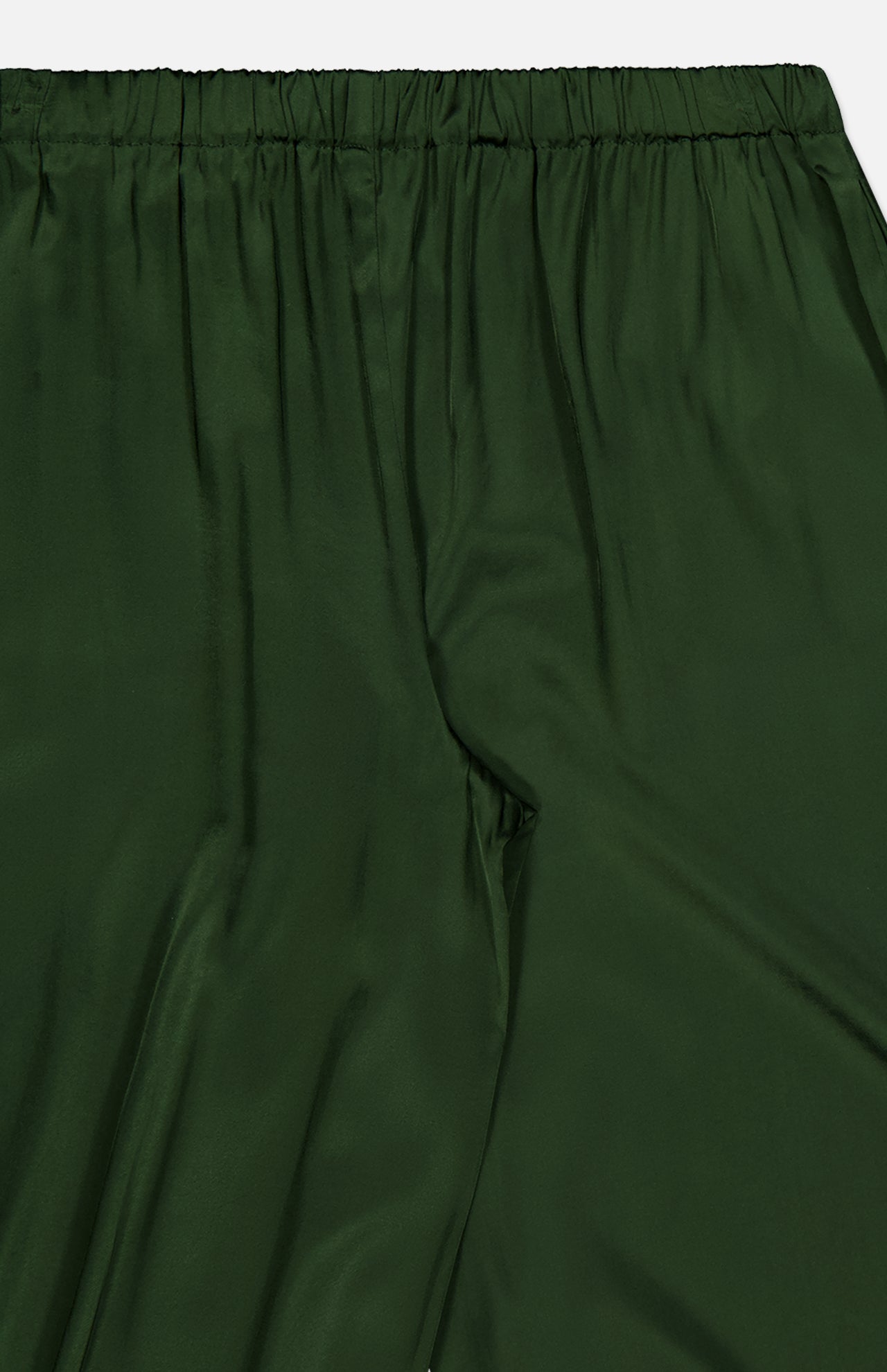 The ALICE + OLIVIA Declan Pull On Genie Pant is shown here in dark green satin with an elastic waistband. The silky charmeuse fabric has a smooth, slightly shiny finish, featuring natural folds and creases from the waist to mid-thigh.