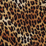 The Delania Long Sleeve Turtleneck Top by ALICE + OLIVIA showcases a brown, tan, and black leopard print with irregular, rounded spots reminiscent of natural leopard markings—making it the perfect statement layering piece.