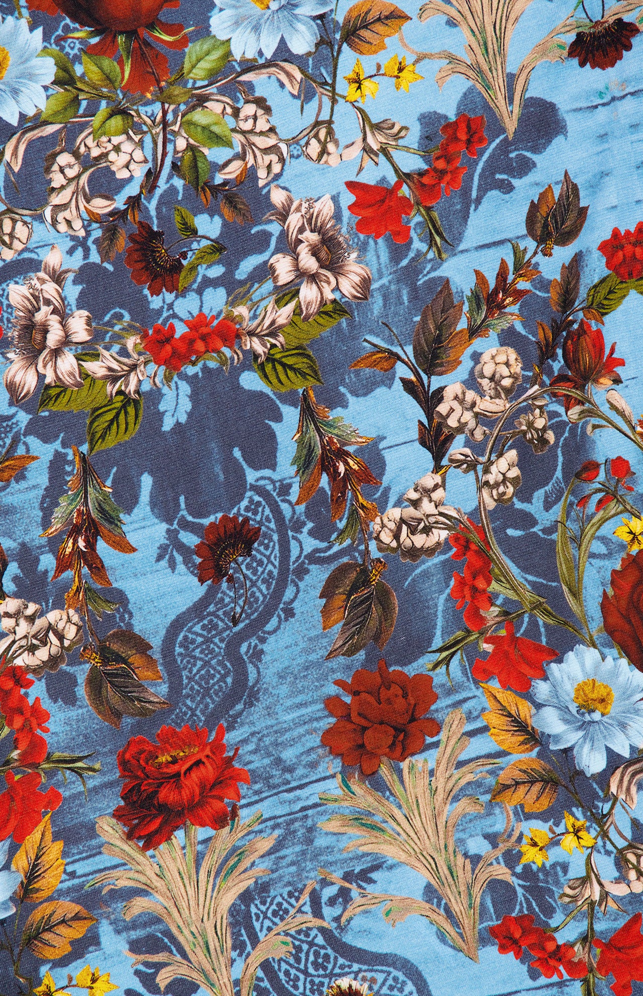 The Delora Folded Turtleneck Mini Dress by ALICE + OLIVIA features a blue floral pattern with red, white, yellow, and blue flowers, green and brown leaves, and a subtle lace-like background for a striking look.