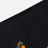 Close-up of a black fabric with a dark floral pattern featuring yellow, orange, and purple flowers and green leaves against a plain background—ideal for crafting the Dylan High Rise Wide Leg Pant from ALICE + OLIVIA for vibrant style.