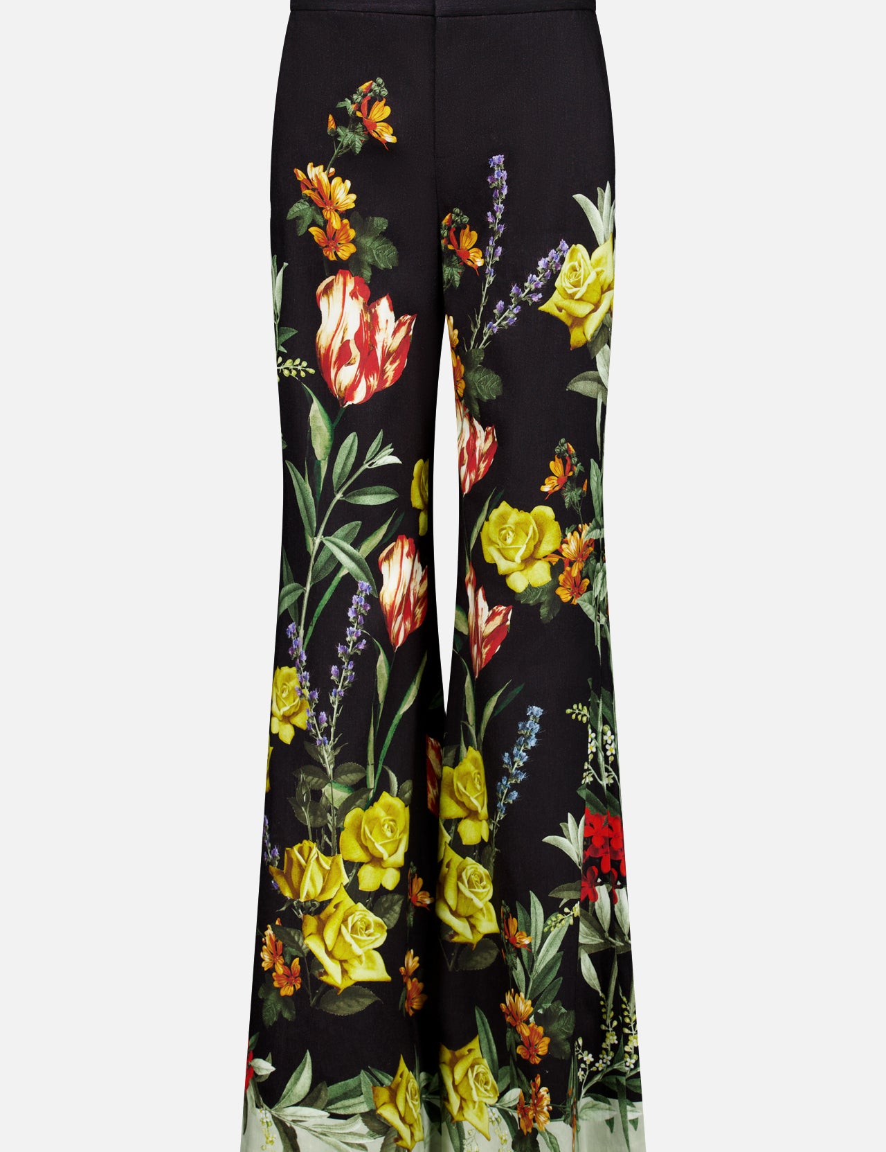 The Dylan High Rise Wide Leg Pant by ALICE + OLIVIA features a black flared silhouette adorned with a vibrant dark floral pattern in red, yellow, and orange flowers with green leaves on both legs, shown against a plain white background.