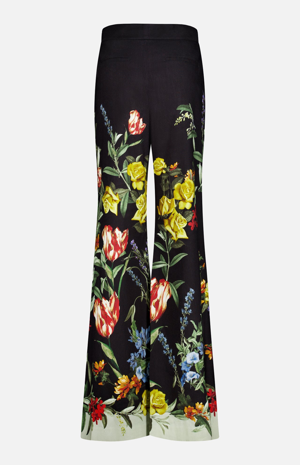 The photo shows the back view of the Dylan High Rise Wide Leg Pant by ALICE + OLIVIA—black, high-waisted linen trousers featuring a vibrant dark floral pattern with red, yellow, and blue flowers, green leaves, and a light-colored hem at the bottom.