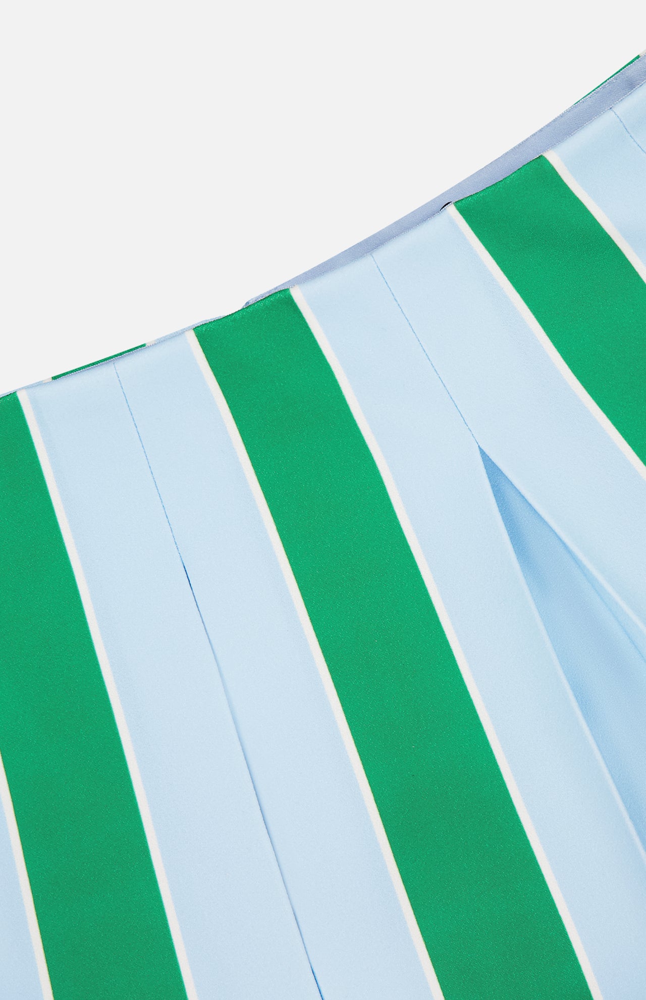 Close-up of the Emilie Low Rise Wide Pleated Mini Skirt by ALICE + OLIVIA, featuring green and light blue vertical stripes separated by thin white lines. The fabric has a smooth texture and structured, preppy look.