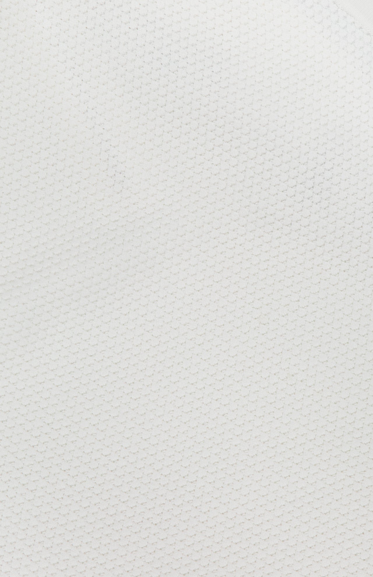Close-up of the ALICE + OLIVIA Heidi Halter Neck Tank Top in white, showcasing its soft, lightweight fabric with a subtle honeycomb texture for an effortlessly refined and quiet luxury look.