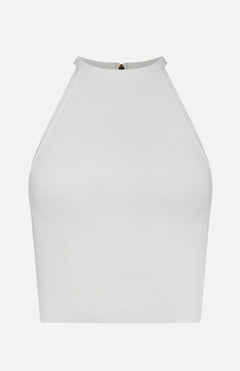 The ALICE + OLIVIA Heidi Halter Neck Tank Top is a sleeveless white crop with textured, fitted fabric, a high neckline, and a subtle back zipper—an elevated take on the classic tank.