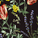 The Julia Scoop Neck Mini Dress by ALICE + OLIVIA features a vibrant, colorful floral pattern with yellow roses, red and white tulips, lavender, and green leaves on a black background. This eye-catching design covers the stretchy twill fabric in a classic mini dress silhouette, with dense overlapping flowers and foliage for a bold statement look.