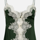 The Julietta Button Front Cutaway Lace Slip Top by ALICE + OLIVIA features a dark green satin finish, thin straps, and intricate white lace detailing along the front and neckline for a stylish, elegant, lingerie-inspired look.