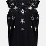 The Micah Embellished Muscle T-shirt by ALICE + OLIVIA is a sleeveless black tank with vibrant beaded and jeweled floral embellishments and crystal details in a symmetrical front design.