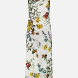 The Montana Slim Strappy Back Maxi Dress by ALICE + OLIVIA is a sleeveless white maxi dress with thin spaghetti straps, featuring a vibrant floral print in red, yellow, orange, and purple flowers with green leaves. This long, form-fitting dress combines simple elegance and colorful design—perfect for summer occasions.