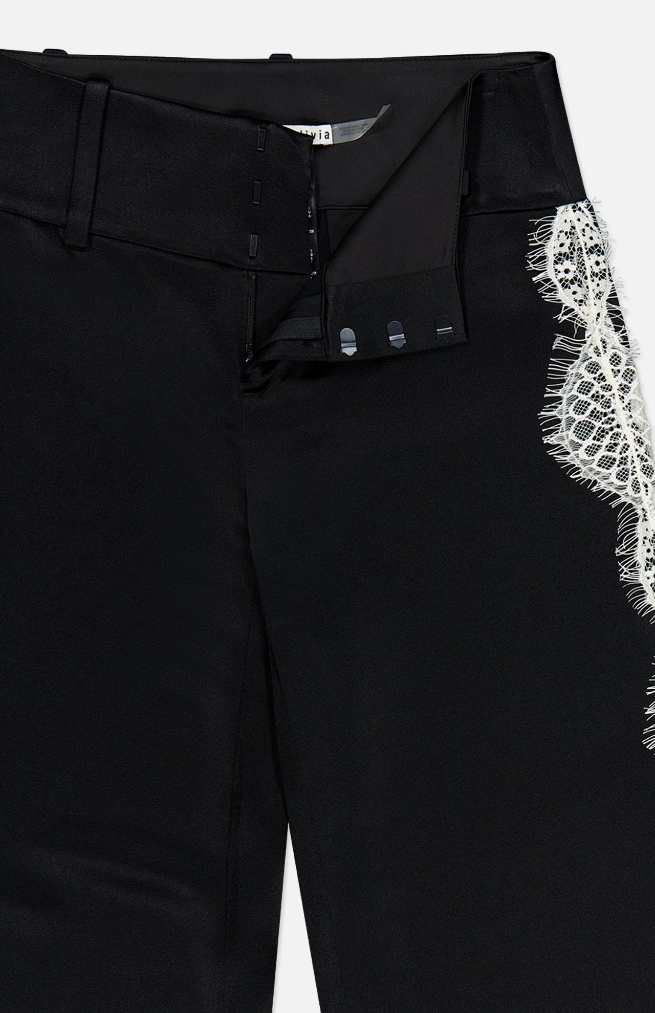 Close-up of Olivia Pant with Cutaway Lace Godet by ALICE + OLIVIA, featuring an open waistband with hook-and-bar closure, inner lining, and cutaway lace godet detail at the right thigh.