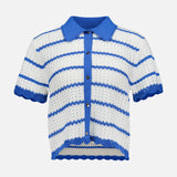 The Randall Pointelle Polo Cardigan by ALICE + OLIVIA is a short-sleeved, collared crochet shirt featuring blue and white stripes, blue buttons down the front, and scalloped edges at the sleeves and hem—a perfect summer knitwear piece that blends pointelle polo cardigan charm with airy sophistication.