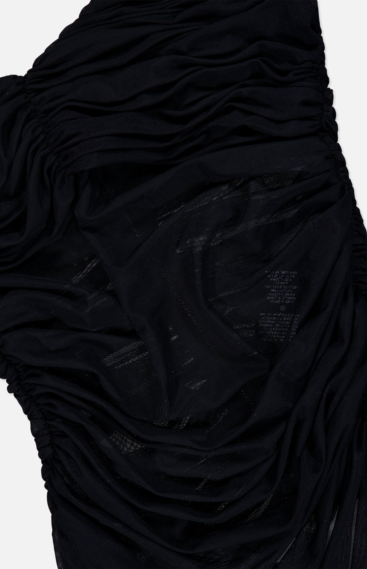 Close-up of black ruched mesh fabric with semi-sheer sections, softly gathered and draped to showcase detailed texture and stitching—part of the Renee Sheer Soft V-Neck Ruched Tank Bodysuit by ALICE + OLIVIA.