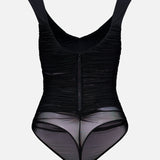The ALICE + OLIVIA Renee Sheer Soft V-Neck Ruched Tank Bodysuit features wide straps, a front zipper, and sheer ruched mesh panels around the hips and lower abdomen, with a flattering thong back—shown against a plain white background.