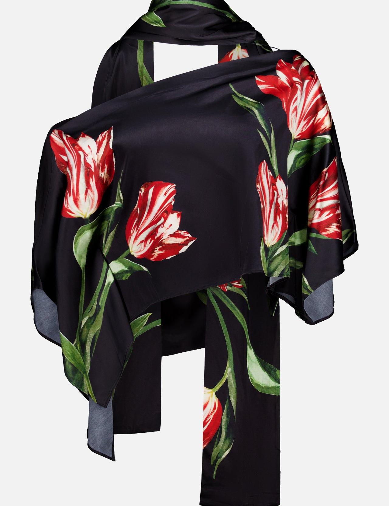 The Rita Off The Shoulder Draped Top with Scarf by ALICE + OLIVIA pairs a cropped black off-the-shoulder top with a luxe black silk charmeuse scarf adorned with bold red and white tulip prints and green leaves, artfully draped to highlight the striking floral pattern.