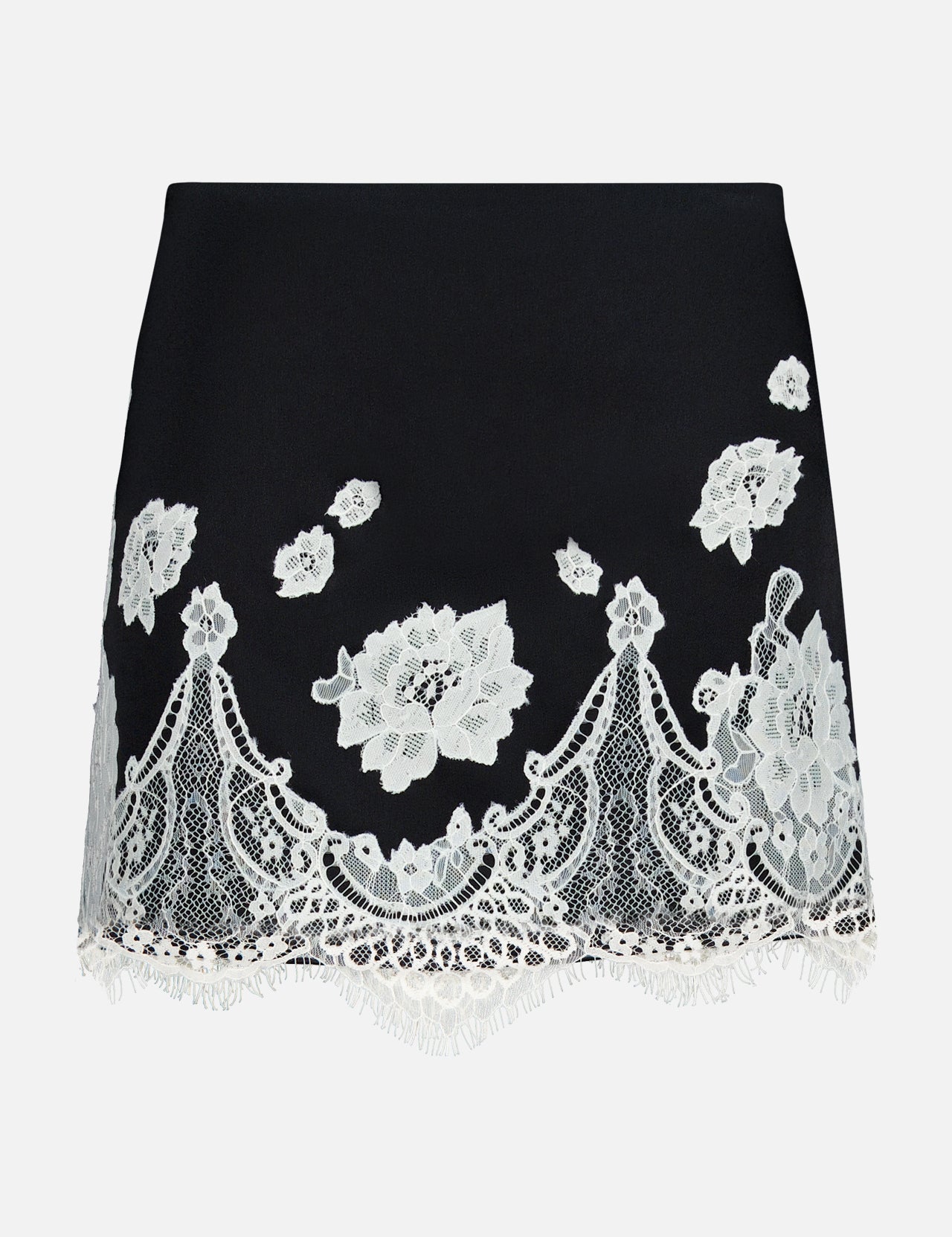 The Rubi Lace Trim Low Rise Micro Skirt by ALICE + OLIVIA is a black micro skirt with white floral lace embroidery, a scalloped fringed hem, and delicate cutwork lace trim for an elegant touch.