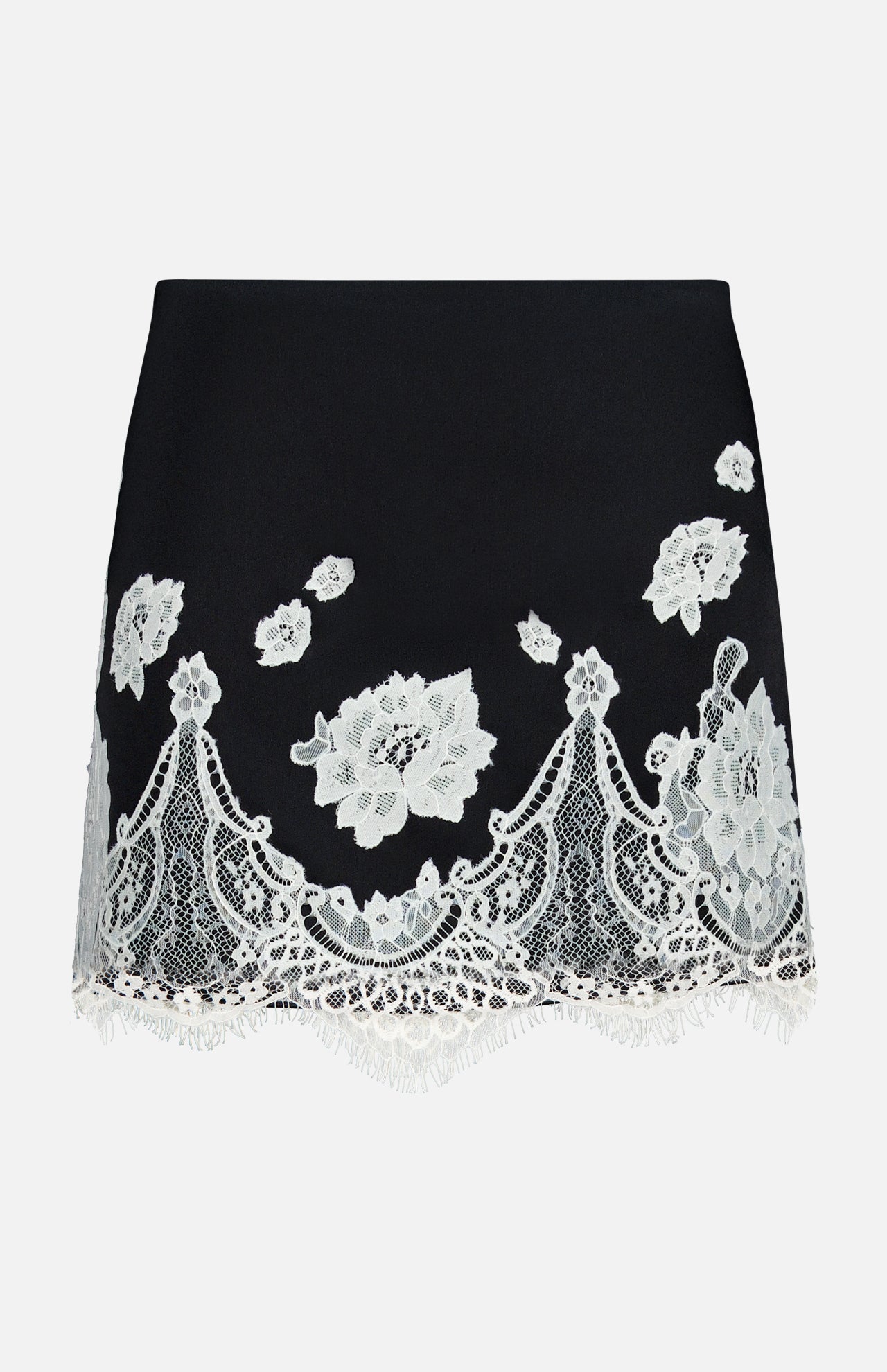 The Rubi Lace Trim Low Rise Micro Skirt by ALICE + OLIVIA is a black micro skirt with white floral lace embroidery, a scalloped fringed hem, and delicate cutwork lace trim for an elegant touch.