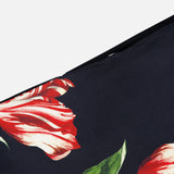 Close-up of the Rubi Low Rise Floral Skirt by ALICE + OLIVIA, showcasing a romantic print with red and white tulips and green stems and leaves against a black background.