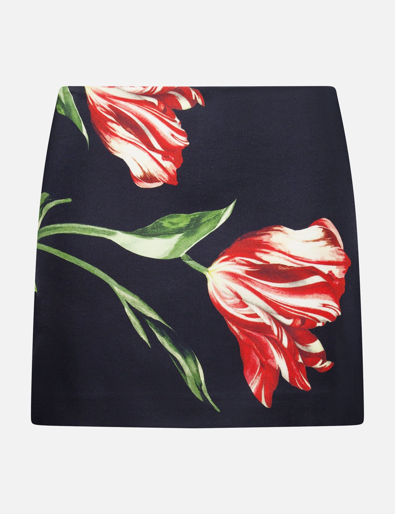 The ALICE + OLIVIA Rubi Low Rise Floral Skirt showcases a striking large red and white tulip print with vivid green leaves on a black mini silhouette, displayed flat against a white background—an ideal piece to bring romantic flair to your wardrobe.