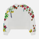 The Russell Embellished Relaxed Crewneck Sweatshirt by ALICE + OLIVIA is a white cropped-fit sweatshirt adorned with colorful floral and delicate sequin embroidery in red, yellow, green, and purple flowers and leaves on the back and sleeves against a plain white background.
