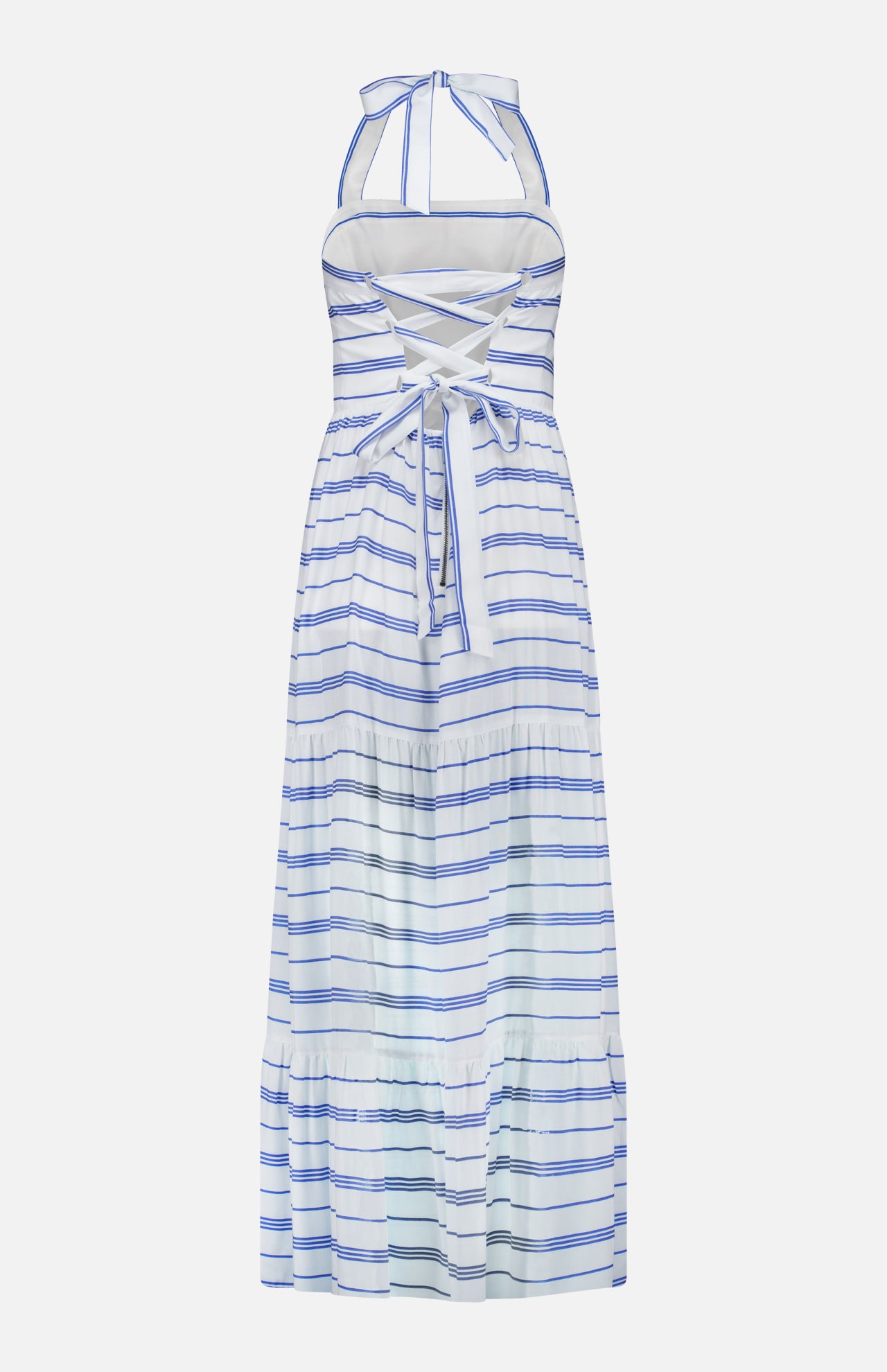 The Saige Halter Tiered Maxi Dress by ALICE + OLIVIA is a sleeveless, white maxi dress with blue stripes, featuring a halter neckline and a crisscross lace-up back. Designed with a tiered skirt and finished with a bow tied at the lower back, this nautical-inspired dress is crafted from light, summery fabric for an effortlessly chic look.