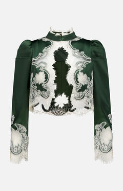 The Thomasina Puff Sleeve Cropped Jacket by ALICE + OLIVIA is a dark green, long-sleeve jacket featuring structured shoulders, puff sleeves, a high neck, floral patterns, and white bloom cutwork lace detailing in a cropped silhouette. The jacket is displayed against a plain white background.