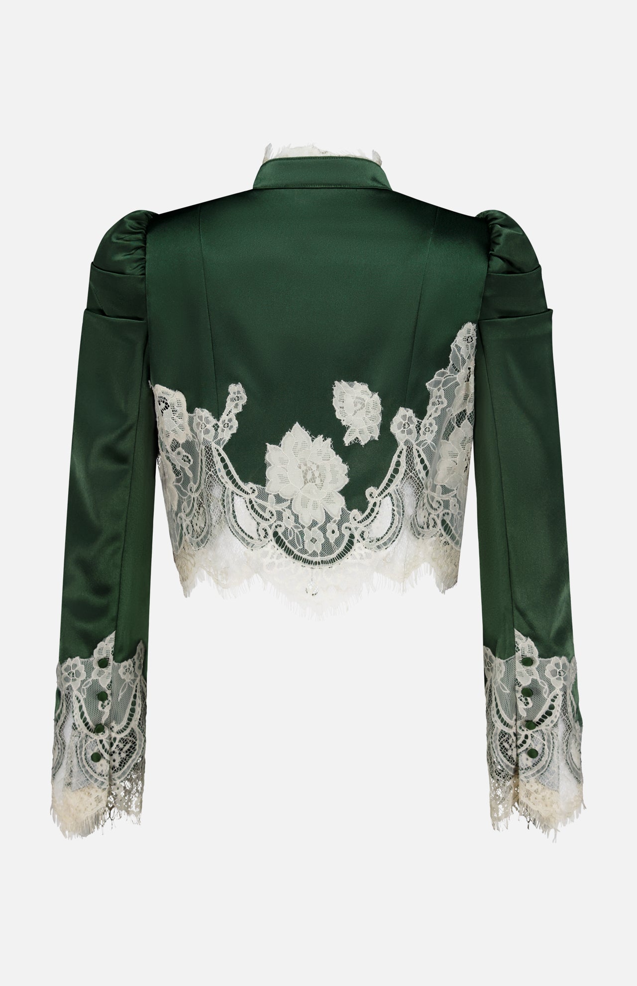 The Thomasina Puff Sleeve Cropped Jacket by ALICE + OLIVIA is a dark green satin piece with stylish puff sleeves, featuring delicate white bloom cutwork lace florals across the back and cuffs, and finished with a scalloped lace hem, shown against a plain white background.