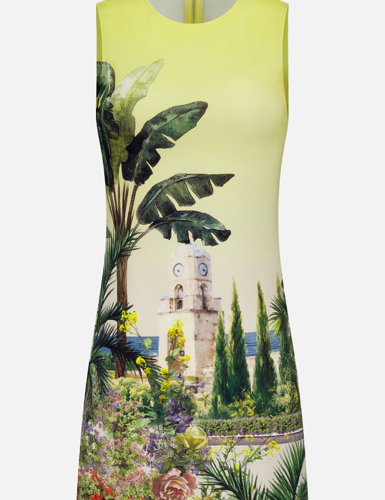 The Wynell Staceface Fitted Mini Dress by ALICE + OLIVIA is a sleeveless yellow mini dress showcasing a scenic print with tropical plants, flowers, trees, a stone clock tower, and sea views—perfect for effortless summer style.