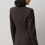 A person viewed from behind wearing a RALPH LAUREN COLLECTION Mini Herringbone Blazer in a tailored dark brown wool with a subtle mini-herringbone pattern.