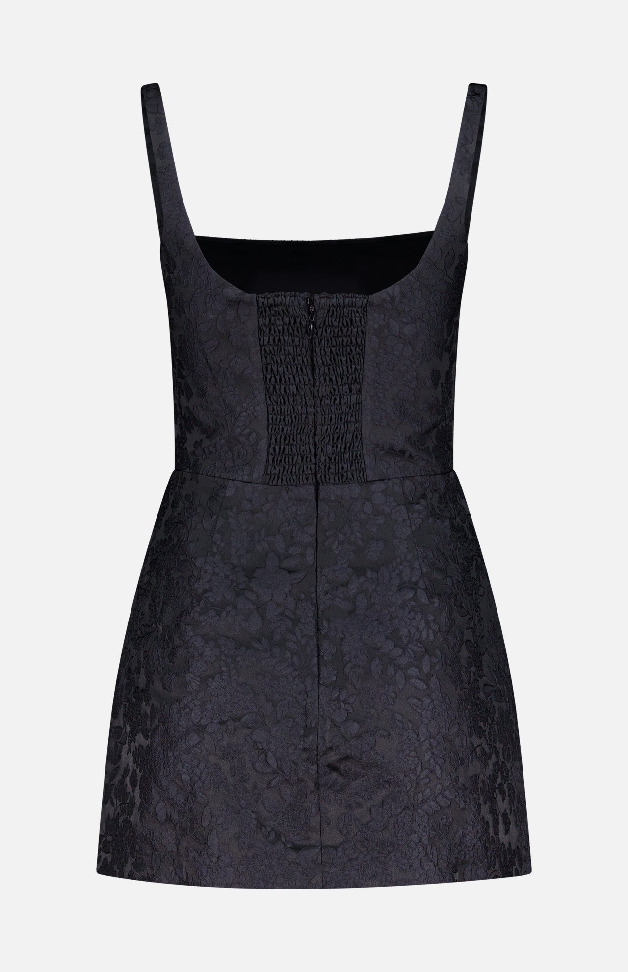 The AMANDA UPRICHARD Rhonda Floral Print Romper is a sleeveless black mini with a square neckline, fitted bodice, smocked center panel, and subtle jacquard floral pattern, displayed on a plain white background.